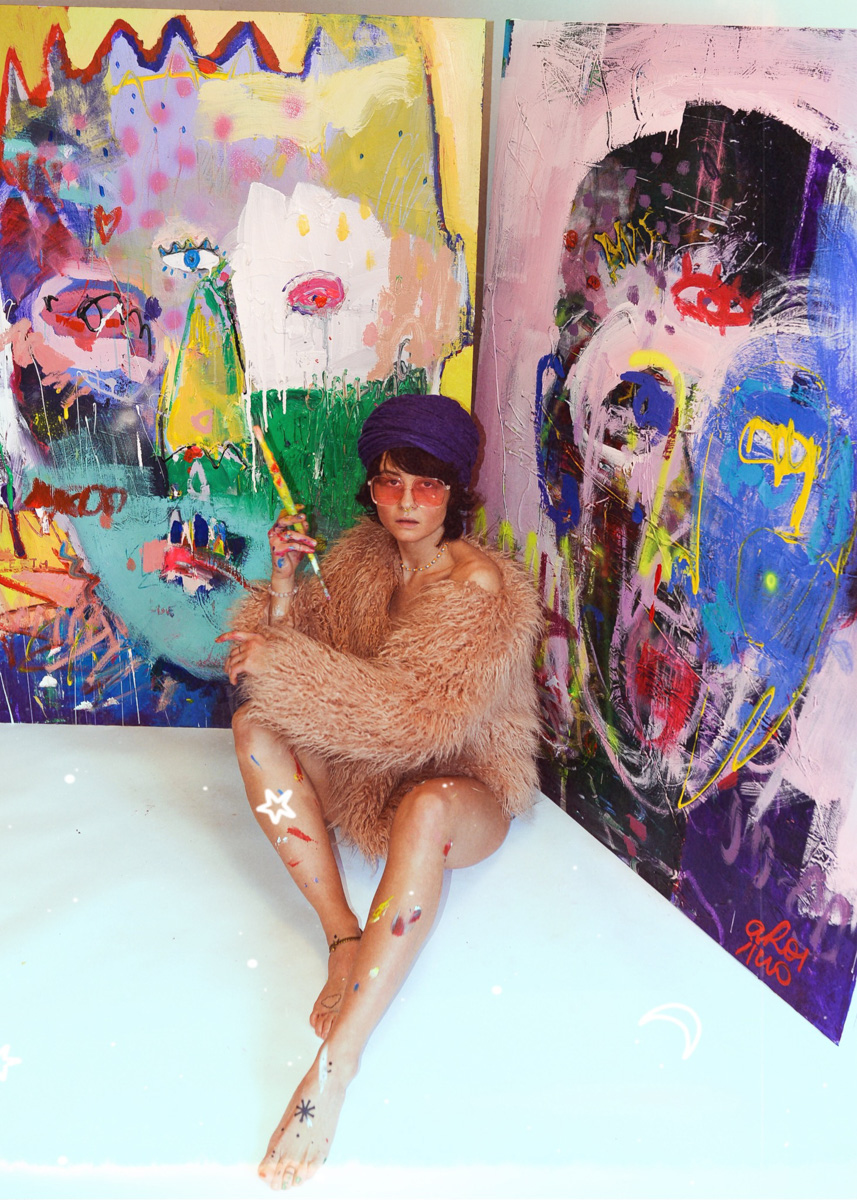 Painter Ara Radvilė in front of “Golden Teeth” and “Rebirth” paintings
